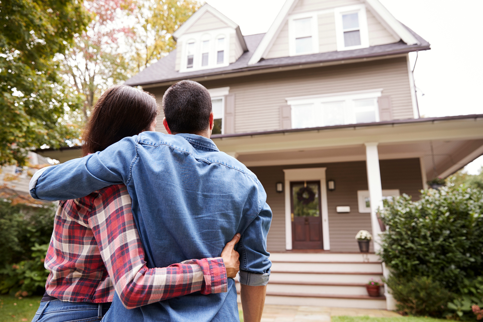 Rear View of Loving Couple Looking at House