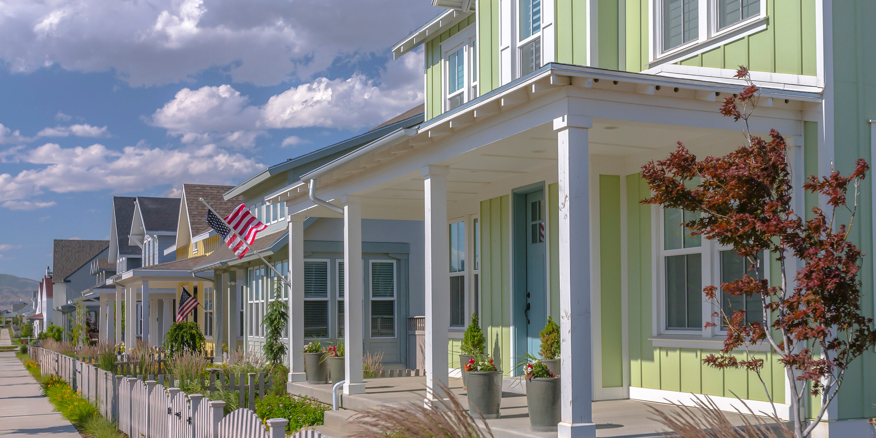 Row of houses with flags in Daybreak Utah